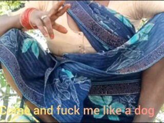 Asking pleasure outdoor in the farm sitting wearing saree .