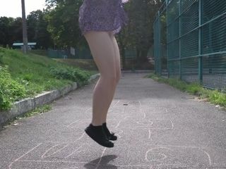 'Crazy girl without panties playing hopscotch in public park'